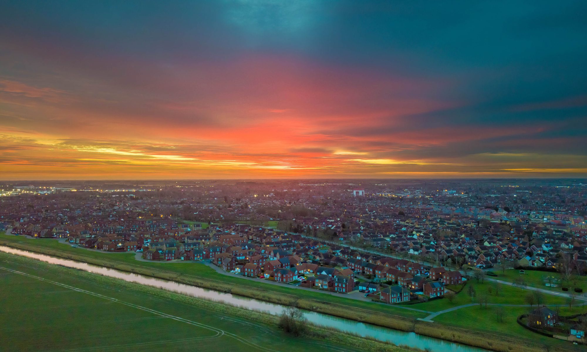 Aerial drone view of a winter sunrise over Spalding, Lincolnshire with views of Wygate Park, Vernatt's Drain, Pennygate and the Chatterton Water Tower