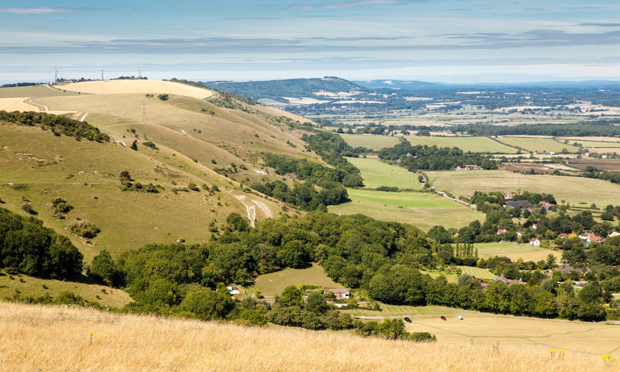 View of the South Downs way, East Sussex, England: view of the fields and the houses from the hill